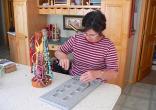 Ana Burrell demonstrating beading techniques in her studio at Bullion Creekside Retreat near Marysvale Utah