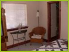 Master Bedroom with reading chairs in Bullion Creekside Cabin